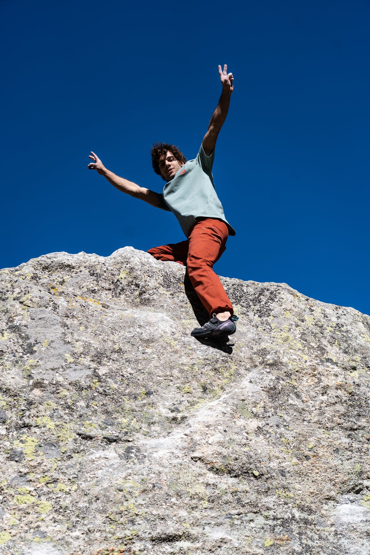 FW26-058 TEE Grey + Pirenei Rust (uomo esulta in cima al masso, cielo blu)